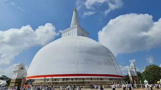 The white dome of the Ruwanwelisaya stupa at Anuradhapura against a clear sky