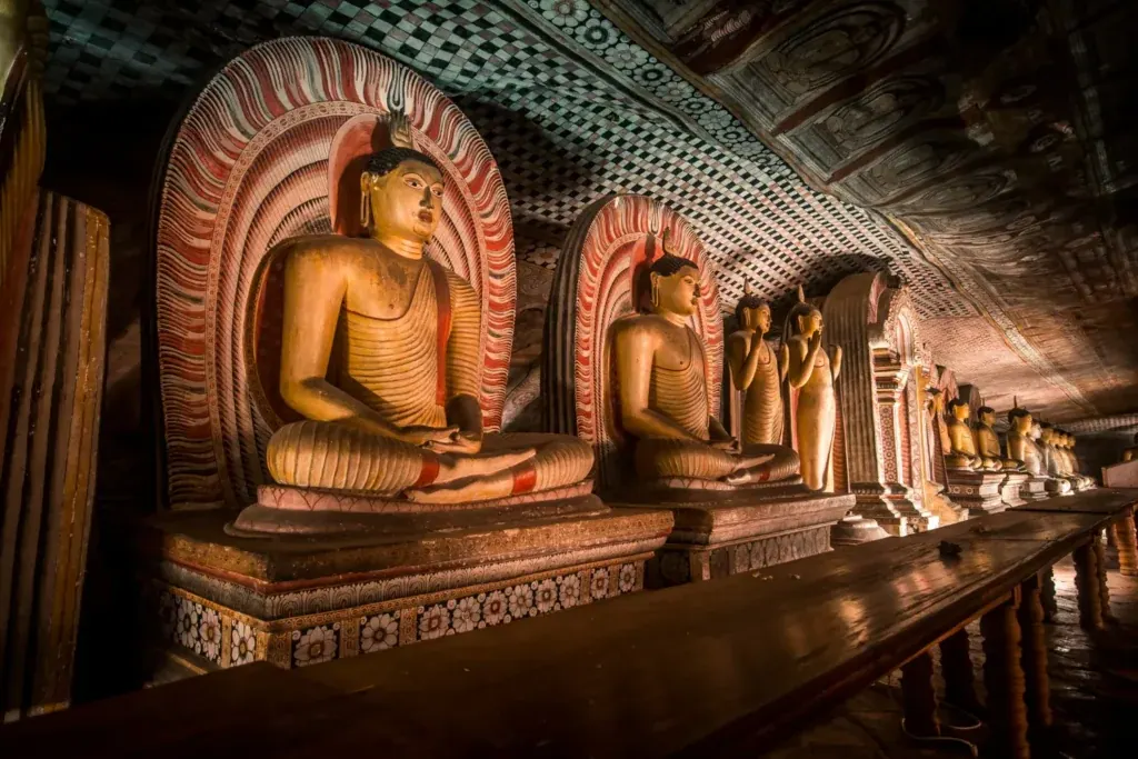 The white colonnaded facade of the Dambulla cave temple complex set into the rock face