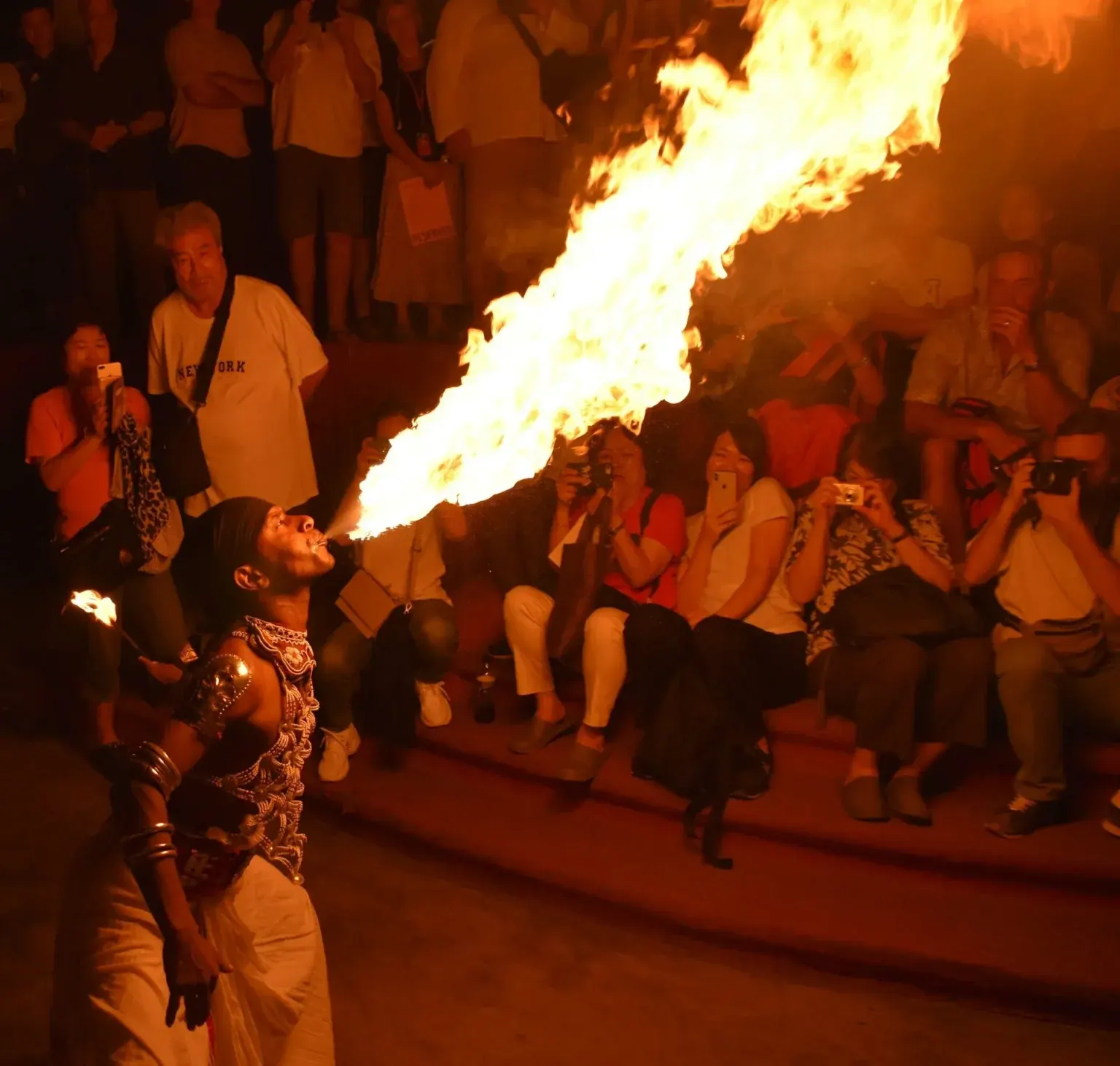 Performers in traditional Kandyan dress on stage at a cultural dance show