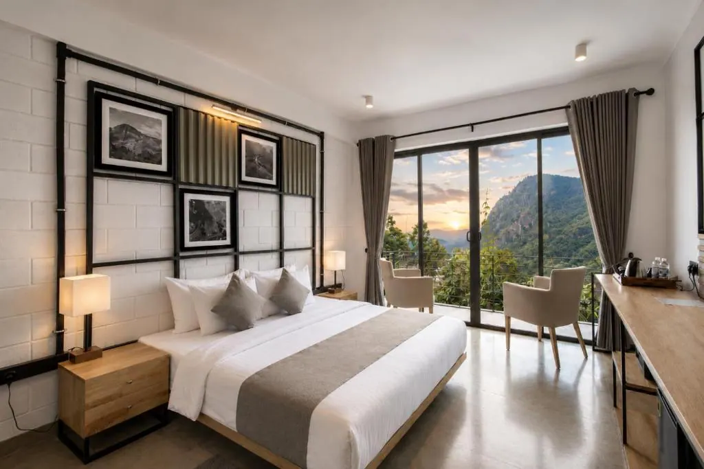 A room at Onrock Boutique Hotel in Ella, its window open to the hills at sunset