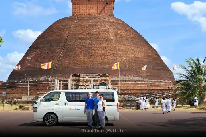 Guests photographed in front of an ancient brick stupa